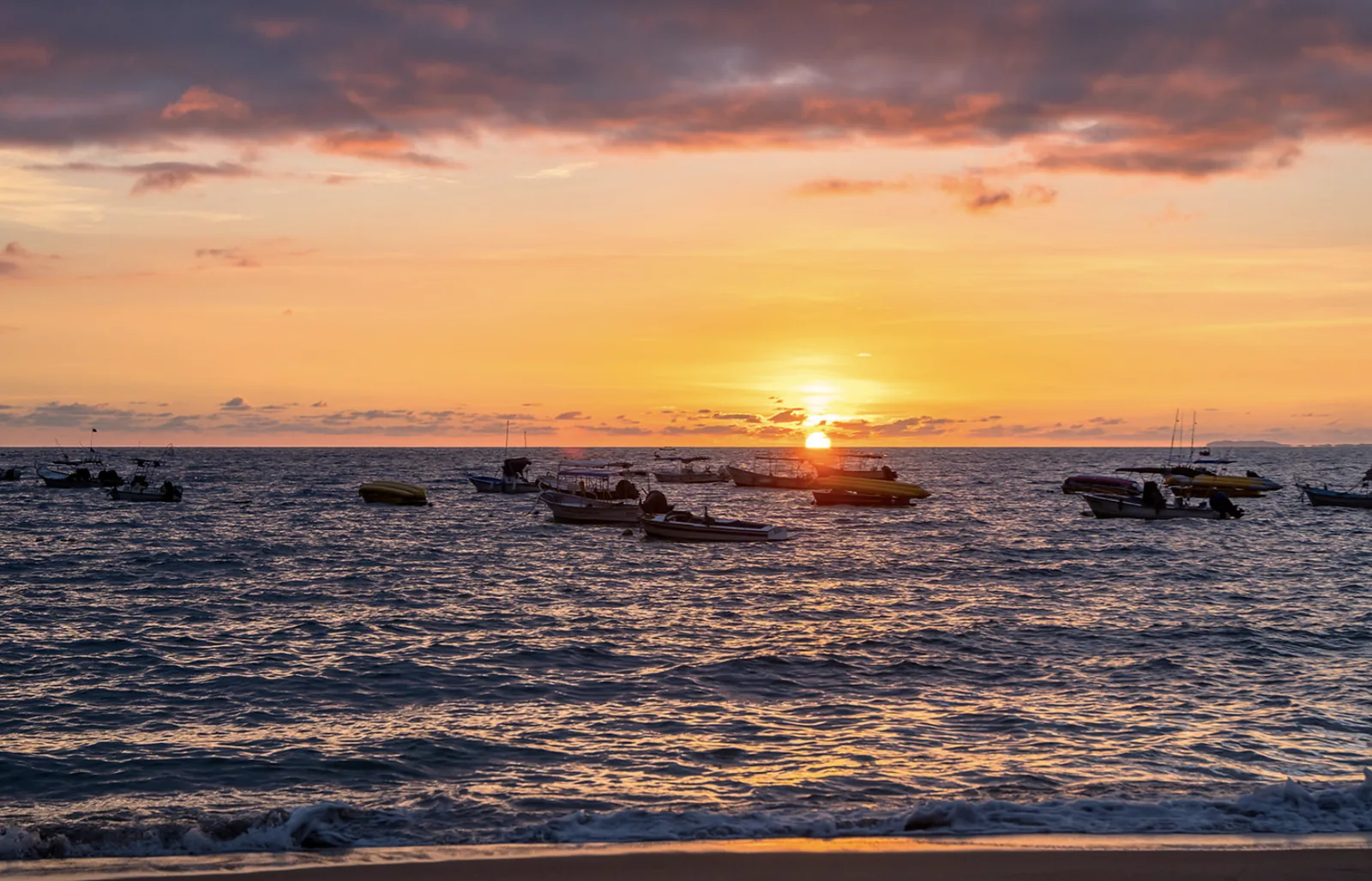 Boats on the Bay of Banderas during a Puerto Vallarta sunset
